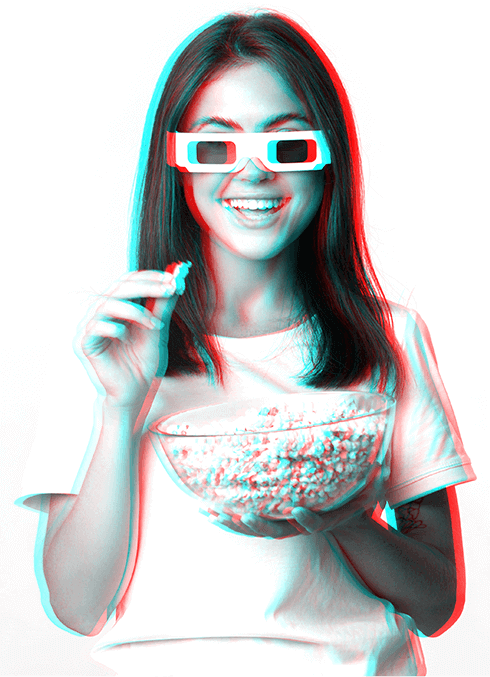 3D photograph of a woman wearing 3D glasses holding a bowl of popcorn. 