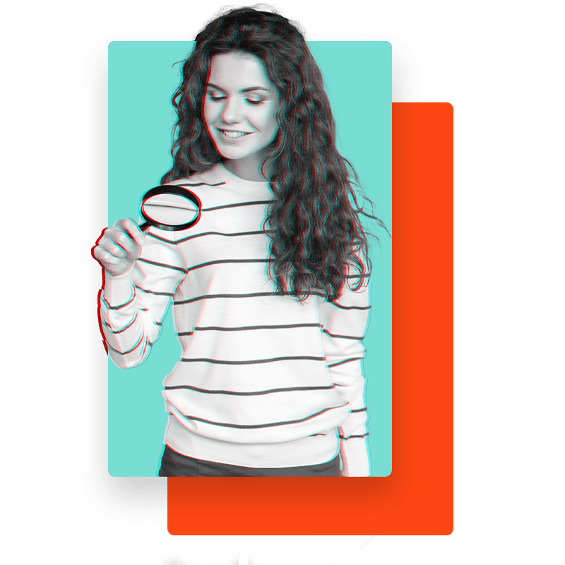 Woman looking through a magnifying glass.